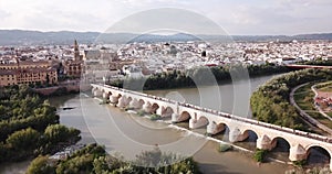 Aerial view of Historic centre of Cordoba with antique Roman Bridge over Guadalquivir river and medieval Mosque