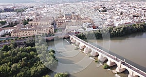 Aerial view of Historic centre of Cordoba with antique Roman Bridge over Guadalquivir river and medieval Mosque