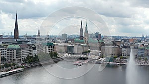 Aerial view of historic city centre on Binnenalster lake waterfront. Several tall towers of city hall and churches. Free