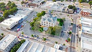 Aerial view historic Hood County Courthouse and Clock Tower in downtown Square Granbury, Texas, USA