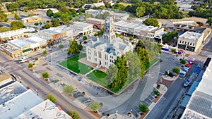 Aerial view historic Hood County Courthouse and Clock Tower in downtown Square Granbury, Texas, USA