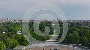 Aerial view of historic landmarks on Piazza Sempione. Fly above grown trees in park towards Castello Sforzesco. Milano