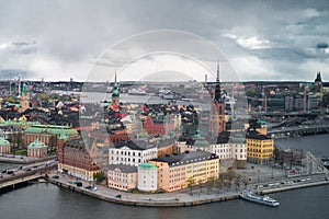 Aerial view on historic part on Swedish capital Stockholm. Old buildings on channel bank. Sad atmosphere under overcast sky photo