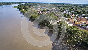 Aerial view of the historic town Santa Cruz de Mompox in sunlight with river and Iglesia De Santa BÃ¡rbara (church of Saint photo