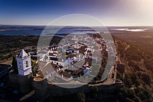 Aerial view of the historic village of Monsaraz in Alentejo with the Alqueva dam reservoir on the background