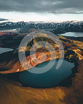 Aerial view of Hnausapollur Crater Lake in the Highlands of Iceland during the golden hour and sunset. Beautiful summer