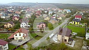 Aerial view of home roofs in residential rural neighborhood area.