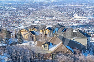 Aerial view of homes on mountain town with panorama view of valley in background