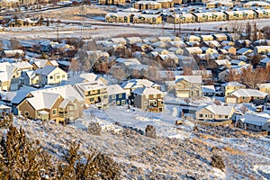 Aerial view of homes in a residential neighborhood blanketed with snow in winter