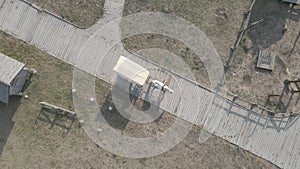 Aerial view of a horse drawn carriage riding a wooden road