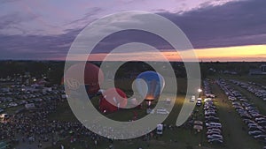 Aerial View of a Hot Air Balloon Festival at Night Firing there Propane Creating a Night Glow