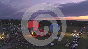 Aerial View of a Hot Air Balloon Festival at Night Firing there Propane Creating a Night Glow