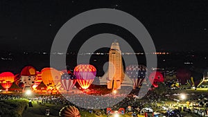 Aerial View of Hot Air Balloons Doing a Balloon Glow With a Space Shuttle at Night on a Summer Nite