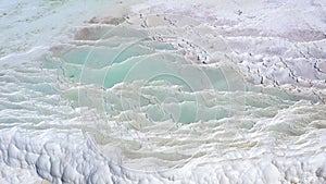 Aerial view of hot springs with blue water white baths. Travertines of Pamukkale in Turkey