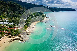 Aerial view of hotels and resorts next to the tropical Nangthong Beach in Khao Lak, Thailand