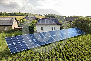 Aerial view of a house with blue solar panels for clean energy