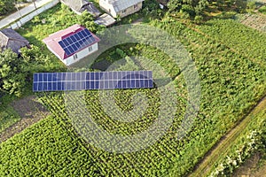 Aerial view of a house with blue solar panels for clean energy