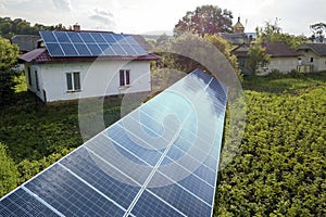 Aerial view of a house with blue solar panels for clean energy