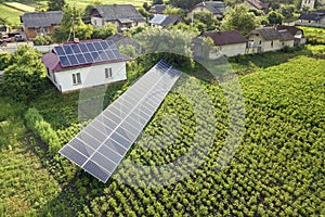 Aerial view of a house with blue solar panels for clean energy