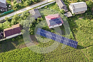 Aerial view of a house with blue solar panels for clean energy