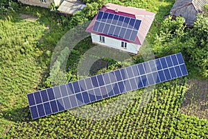 Aerial view of a house with blue solar panels for clean energy