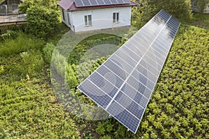 Aerial view of a house with blue solar panels for clean energy