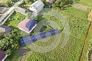 Aerial view of a house with blue solar panels for clean energy