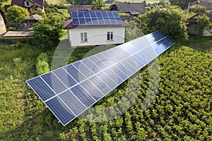 Aerial view of a house with blue solar panels for clean energy