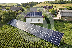 Aerial view of a house with blue solar panels for clean energy