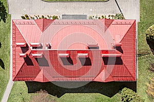 Aerial view of house with red corrugated metal sloping roof