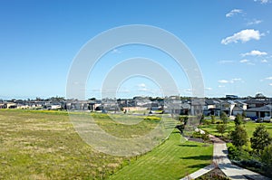 Aerial view of houses in the neighbourhood, and a large block of vacant land. Point Cook VIC Australia