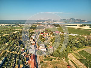 Aerial view of houses roofs and fields