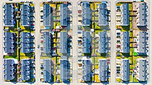 An aerial view of the houses and streets. A residential area in the suburbs. Houses and private yards. View of townhouses from the