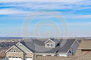 Aerial view of houses with Utah Valley landscape and cloudy blue sky background