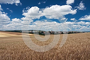 Aerial view of housing estates, in foreground a cereal field