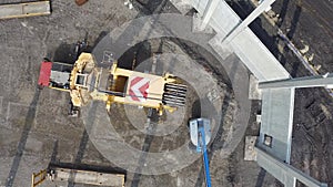 Aerial view of huge crane installing huge reinforced concrete piles on construction site