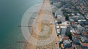 Aerial view of a huge crowded sandy beach in Italy. Summer vacation time