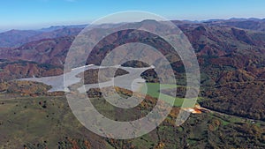 Aerial view of a huge decanting lake, full with mining residuals from a copper and gold mine with cyanidation or cyanide leaching