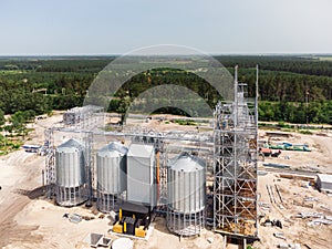 Aerial view of huge modern grain elevator. Food storage, building in progress. Silo farm. Agribusiness development