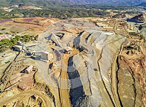 Aerial view of huge, open pit mine with industrial architecture