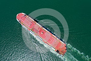 Aerial view of the huge ro-ro ship loading new cars. Automotive container carriers sailing on the sea