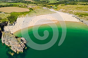 Aerial view of a huge sandy beach and clear waters Broad Haven South, Pembrokeshire, Wales