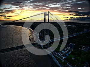 Aerial view of the Humber Bridge spanning across a river in a large city