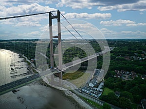 Aerial view of the Humber Bridge spanning across a river in a large city