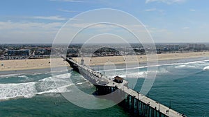 Aerial view of Huntington Pier, beach and coastline during sunny summer day