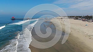 Aerial view of Huntington Pier, beach and coastline during sunny summer day