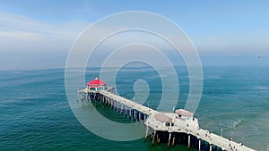 Aerial view of Huntington Pier, beach and coastline during sunny summer day