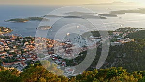 Aerial view of Hvar city, Croatia. Hvar island during sunset. Panoramic shot of the island city and Yachts sailing the