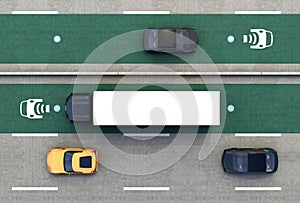 Aerial view of hybrid truck and blue electric car on wireless charging lane