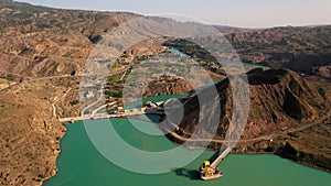 Aerial view of hydroelectric power plant. Toktogul hydroelectric power station on the Naryn River, Kyrgyzstan